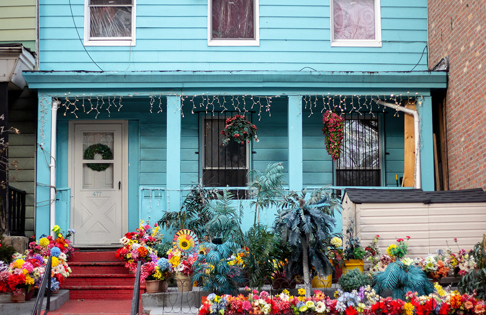 blue house with flowers out front